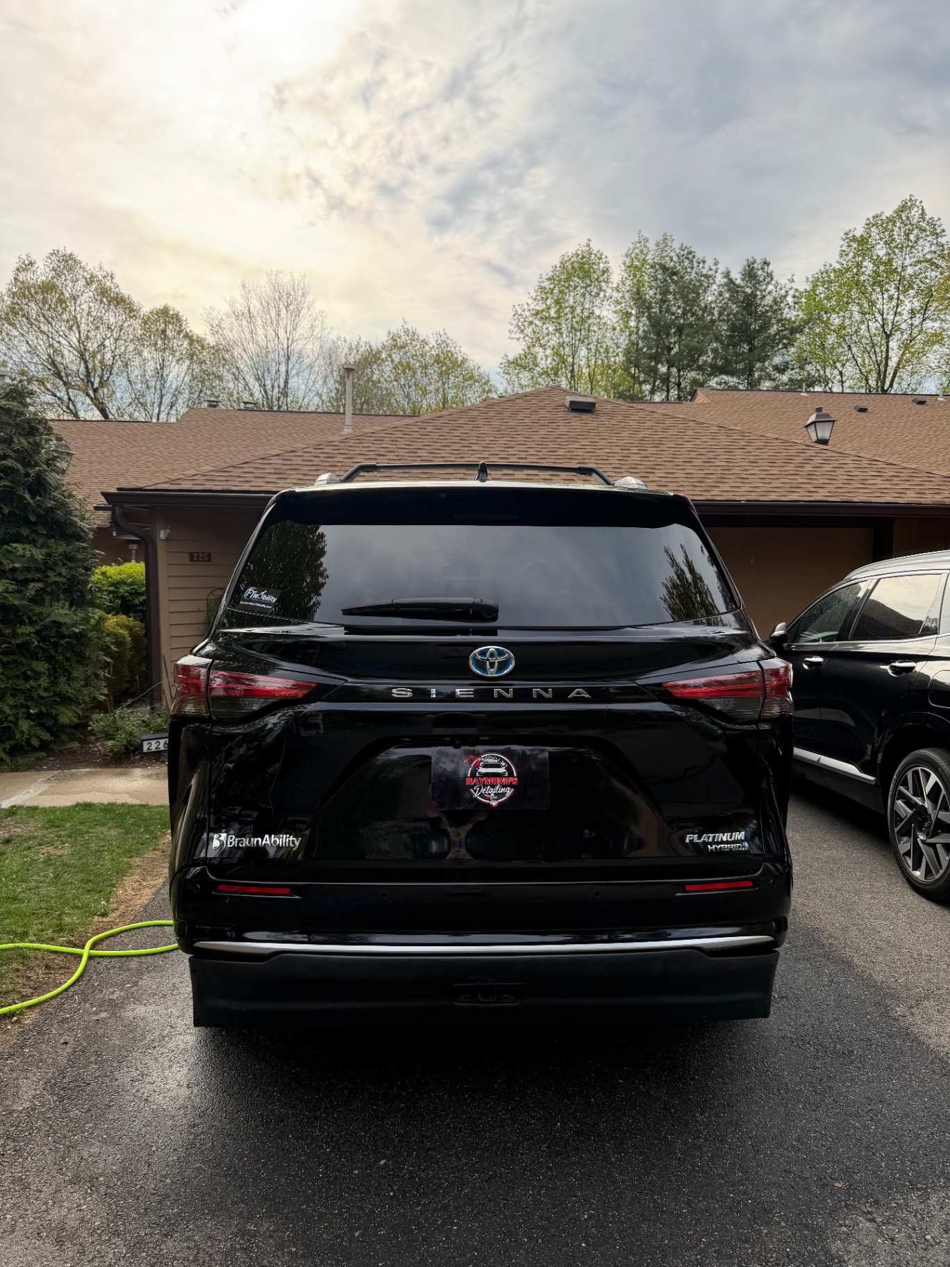 Rear of a black Toyota Sienna detailed in the driveway