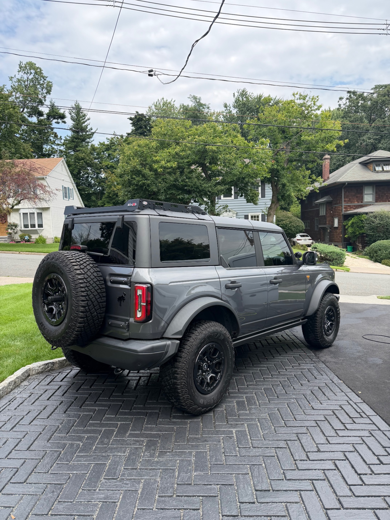 Grey Ford Bronco detailed and gleaming on a paver driveway